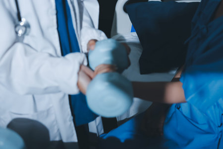 Physical therapist assisting a woman with dumbbell exercise