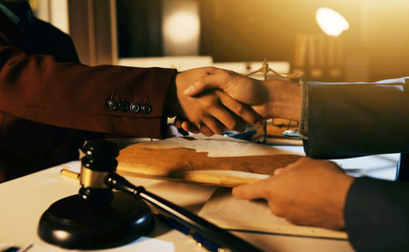 Close up of businessmen or lawyers discussing contract or business agreement at law firm office,...