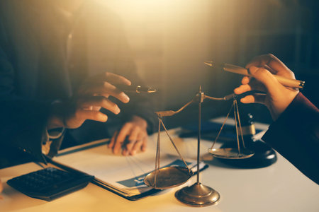 Close up of businessmen or lawyers discussing contract or business agreement at law firm office,...
