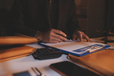 Close up of businessmen or lawyers discussing contract or business agreement at law firm office,...