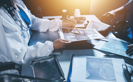 Doctors are meeting at the hospital to discuss treatment options and share experiences with colleagues.の写真素材