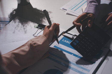 Above table with finance papers, graphs and big data during teamwork meeting with accounting or marketing team discussing budget, strategy or growth development. Closeup of team doing researchの写真素材
