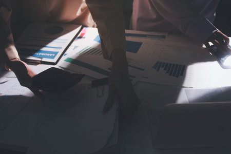 Above table with finance papers, graphs and big data during teamwork meeting with accounting or marketing team discussing budget, strategy or growth development. Closeup of SEO team doing researchの写真素材