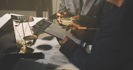 Businesswoman and Male lawyer or judge consult and conference having team meeting with client at law firm in office, Law and Legal services conceptの写真素材