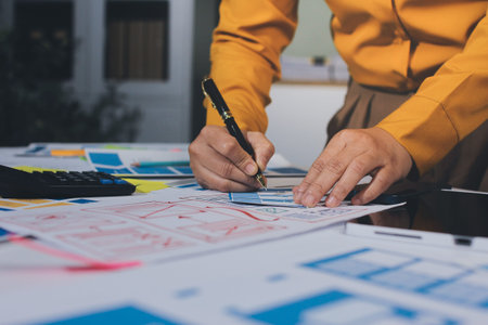 team of UI UX web designer are working together to develop mobile responsive websites with UI UX front end designer previews, UI UX web development ideas, front end designer. application developmentの写真素材