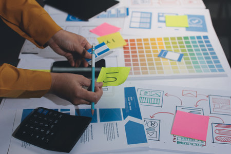 team of UI UX web designer are working together to develop mobile responsive websites with UI UX front end designer previews, UI UX web development ideas, front end designer. application developmentの写真素材