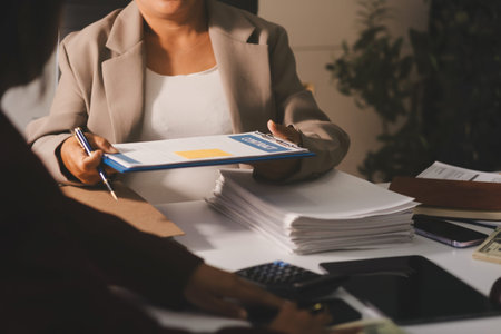 Lawyers having team meeting at law firm in background. Notary with client in officeの写真素材