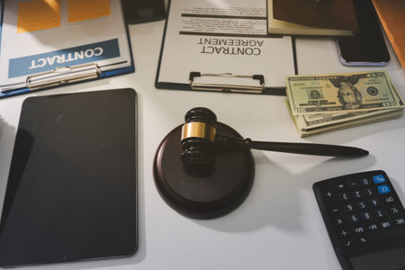 Judge gavel with Justice lawyers having team meeting at law firm in background. Notary with client in officeの写真素材