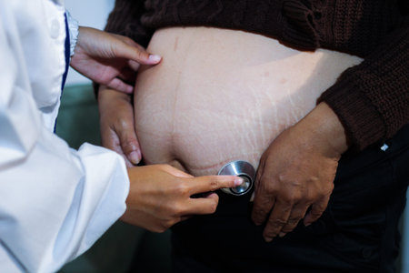 cropped shot of doctor examining pregnant woman during medical consultationの写真素材