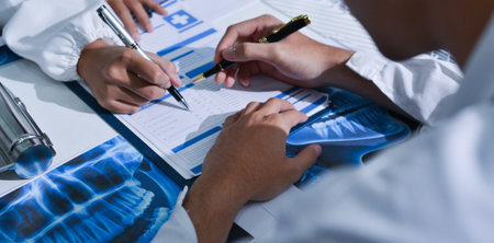 Doctor Explaining X-Ray Results to a Patient Using a Digital Device
