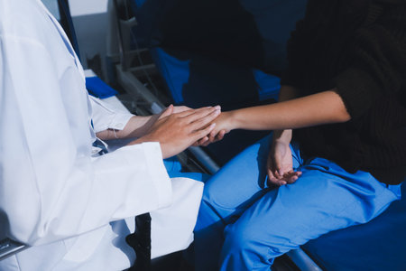 Doctor holding patient's hands offering comfort and supportの写真素材