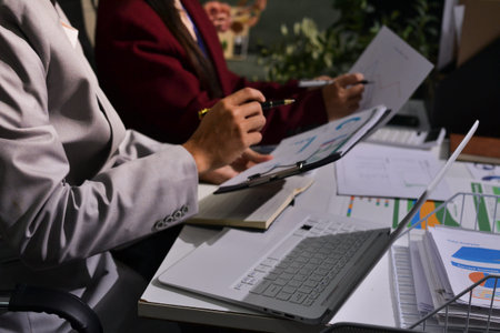Business people analyzing monthly budget and financial report using data and chart to strategize and...