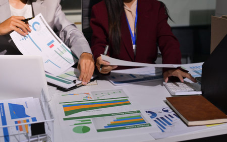 Business people analyzing monthly budget and financial report using data and chart to strategize and...