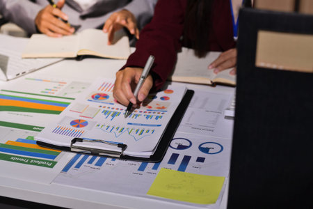 Business people analyzing monthly budget and financial report using data and chart to strategize and...