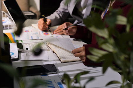 Business people analyzing monthly budget and financial report using data and chart to strategize and...