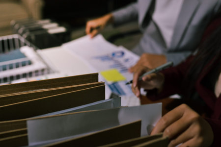 Business people analyzing monthly budget and financial report using data and chart to strategize and plan for their future business while working together in the office.の写真素材