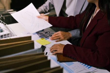 Business people analyzing monthly budget and financial report using data and chart to strategize and plan for their future business while working together in the office.の写真素材