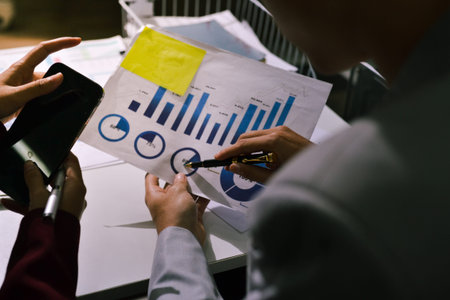 Business people analyzing monthly budget and financial report using data and chart to strategize and plan for their future business while working together in the office.の写真素材