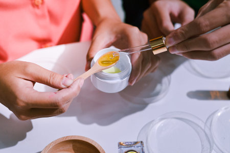Woman making organic cosmetics with aloe in laboratoryの写真素材