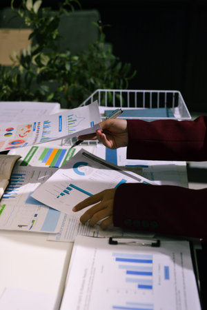 Business people analyzing monthly budget and financial report using data and chart to strategize and plan for their future business while working together in the office.の写真素材