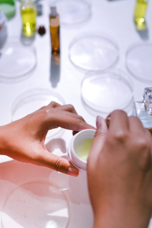 Woman making organic cosmetics with aloe in laboratoryの写真素材