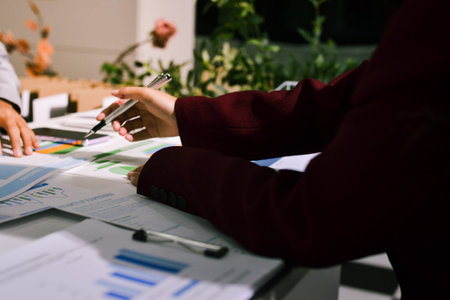 Business people analyzing monthly budget and financial report using data and chart to strategize and plan for their future business while working together in the office.の写真素材