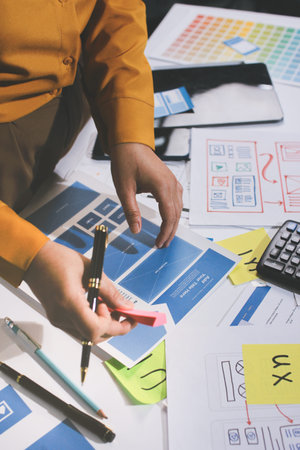 team of UI UX web designer are working together to develop mobile responsive websites with UI UX...