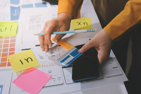 team of UI UX web designer are working together to develop mobile responsive websites with UI UX...