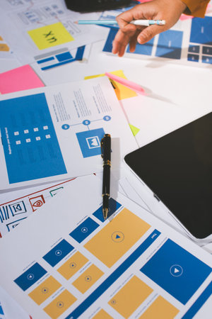 team of UI UX web designer are working together to develop mobile responsive websites with UI UX...