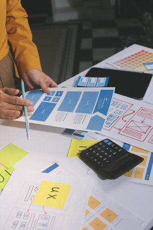 team of UI UX web designer are working together to develop mobile responsive websites with UI UX front end designer previews, UI UX web development ideas, front end designer. application developmentの写真素材