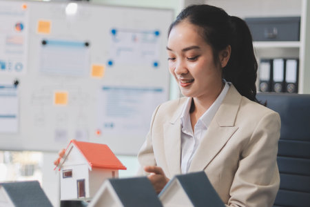 real estate agent home miniature model on documents sale and purchase of apartment notarial deedの写真素材