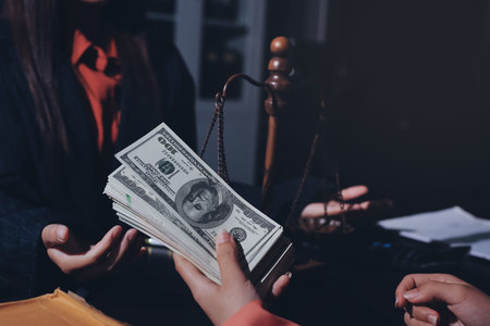 Consultation and conference of professional businesswoman and Male lawyers working and discussion having at law firm in office. Concepts of law, Judge gavel with scales of justiceの写真素材