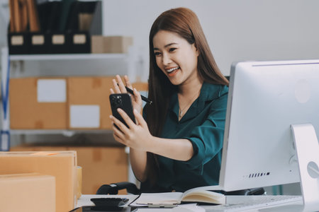 Starting small businesses SME owners female entrepreneurs check online orders to prepare to pack the boxes, sell to customers, sme business ideas online.の写真素材