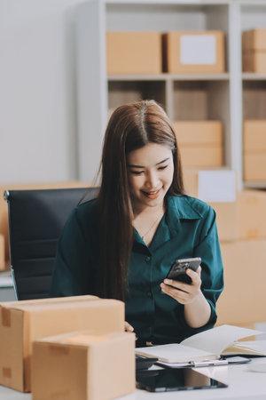 Starting small businesses SME owners female entrepreneurs check online orders to prepare to pack the...
