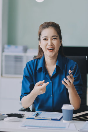 Young Asian businesswoman giving presentation
