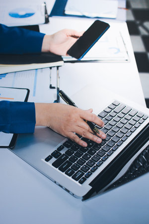 Businesswomen analyzing financial data, discussing investment strategy in office
