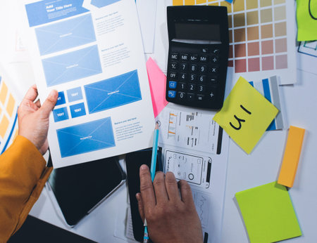 team of UI UX web designer are working together to develop mobile responsive websites with UI UX...