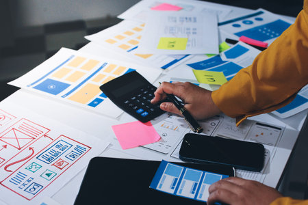 team of UI UX web designer are working together to develop mobile responsive websites with UI UX...