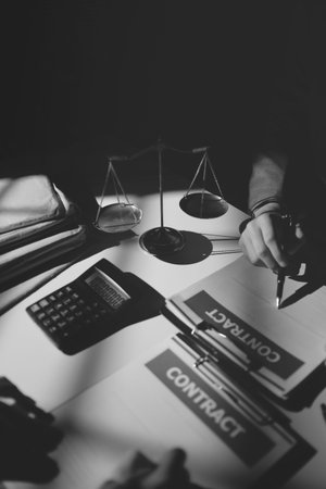 Close up of businessmen or lawyers discussing contract or business agreement at law firm office,...