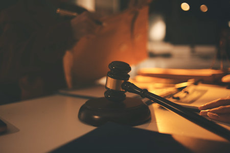 Close up of businessmen or lawyers discussing contract or business agreement at law firm office,...