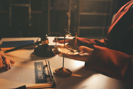 Close up of businessmen or lawyers discussing contract or business agreement at law firm office,...