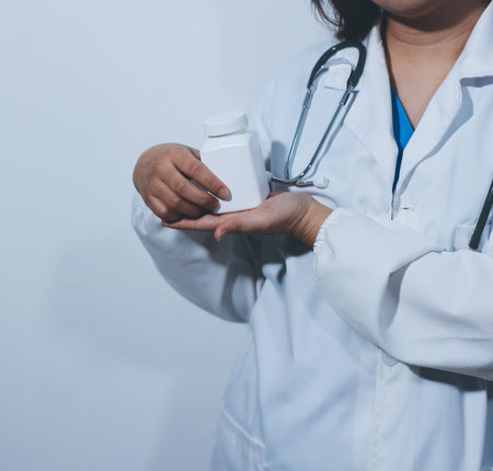 The pharmacist or doctor holding medication or medicine for treatment. Anti biotic pill in the vial.
