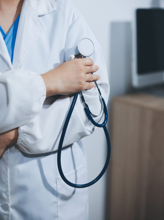 A young male doctor holding a stethoscope
