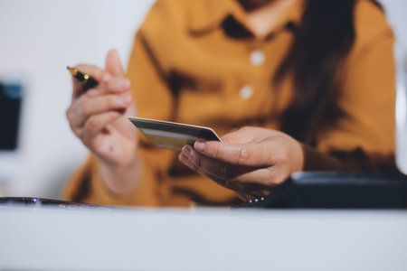 Online payment, Hands of woman holding a credit card and using smart phone for online shopping