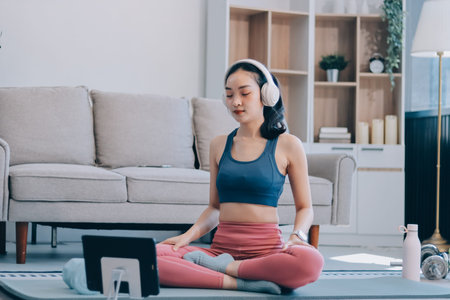 Young Asian sporty attractive people practicing yoga lesson with instructor. Asia group of women...