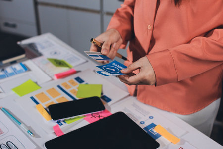 team of UI UX web designer are working together to develop mobile responsive websites with UI UX...