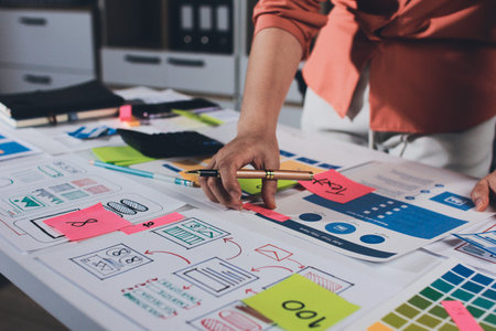 team of UI UX web designer are working together to develop mobile responsive websites with UI UX front end designer previewsの写真素材