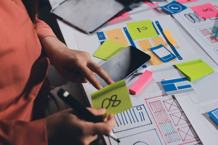 team of UI UX web designer are working together to develop mobile responsive websites with UI UX...