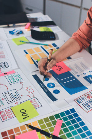 team of UI UX web designer are working together to develop mobile responsive websites with UI UX front end designer previewsの写真素材