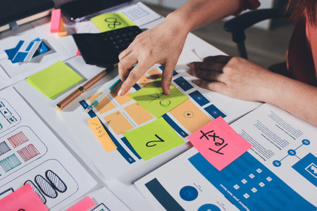 team of UI UX web designer are working together to develop mobile responsive websites with UI UX...
